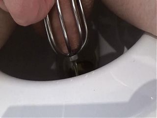 Old Clip from 2018: Pissing through the Plug of Chastity Cage